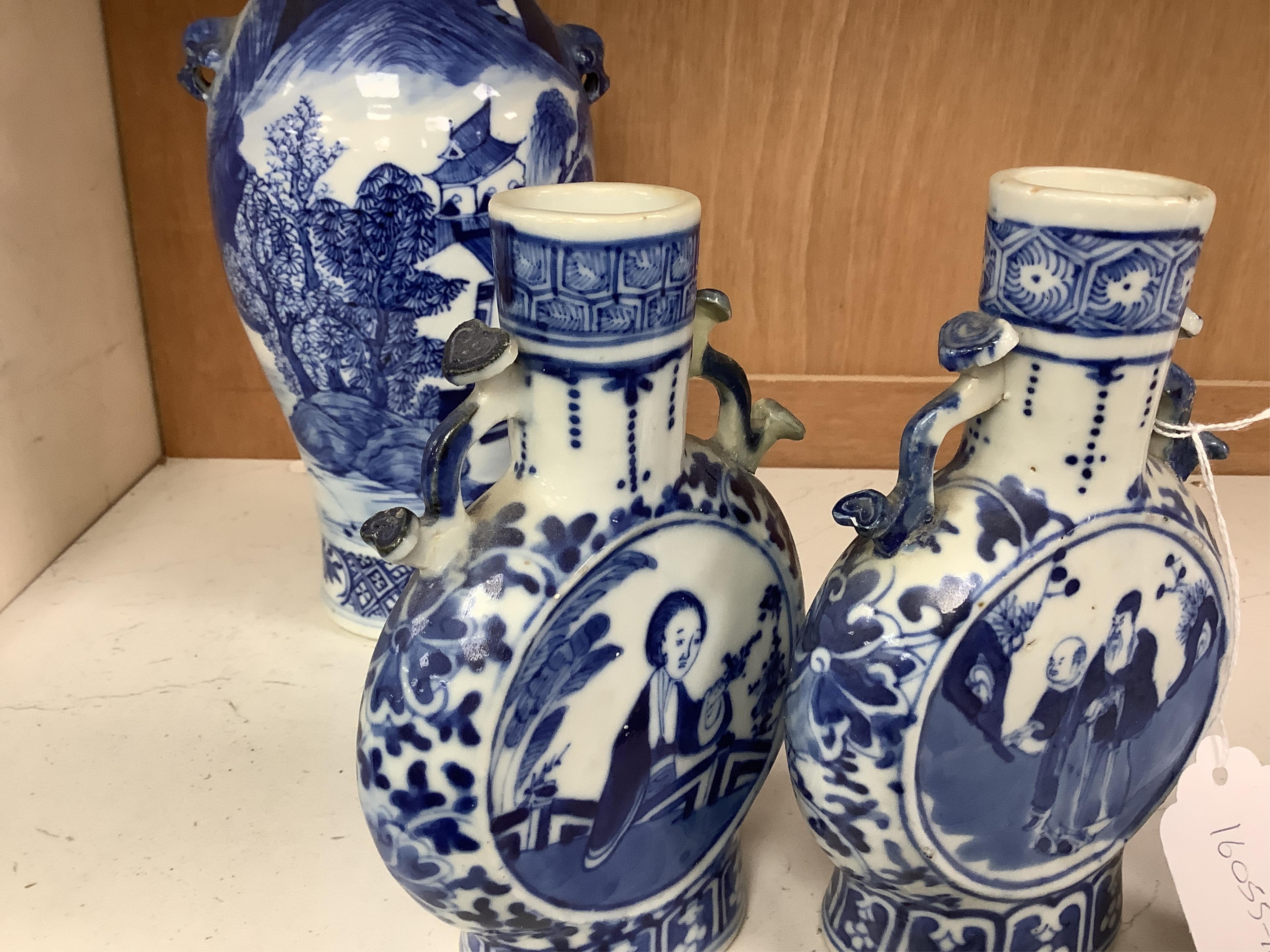 Late 19th century Chinese vases; pair of small Chinese blue and white moon flasks and a larger Chinese blue and white landscape vase, larger vase 22cm high. Condition - one moon flask handle restored, other items fair